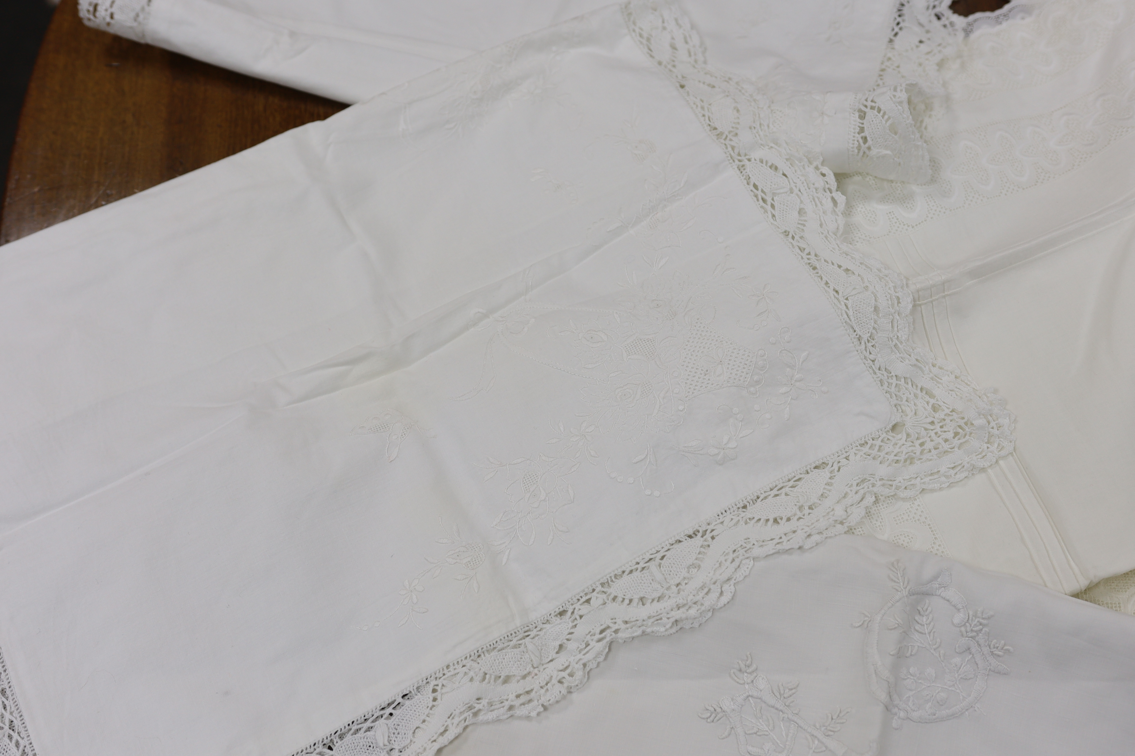 19th-20th century bed linen; a monogrammed sheet, 7ft 6in., and a smaller crochet edged sheet, a pair of French square Anglaise pillow cases, three similar appliqué pillow cases, a frilled single square pillow case and a